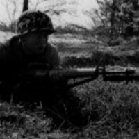 Korean Marine lies in position with his M16 with fixed bayonet